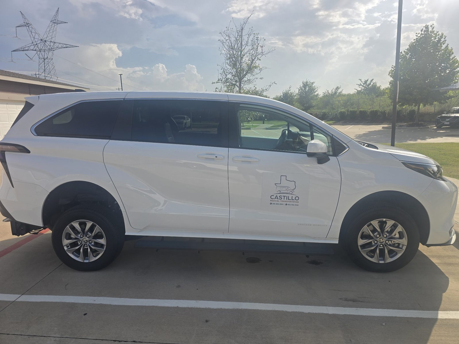 Side profile of a white Castillo Medical Transportation Toyota Sienna vehicle